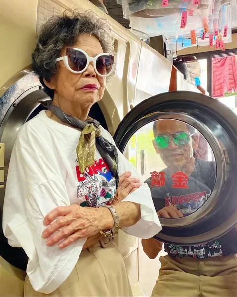 Taiwanese couple wear clothes that were left behind at their laundromat.
