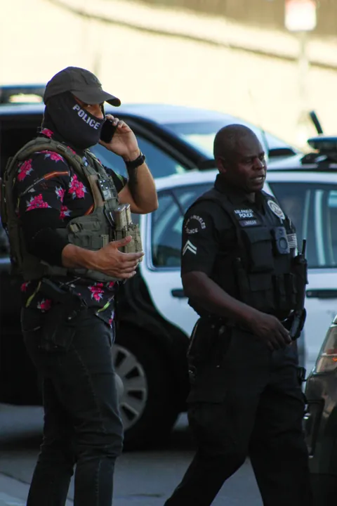 LAPD won’t enforce mask ban; here’s ICE in a POLICE mask, lounging on an LAPD car during arrest [OC]