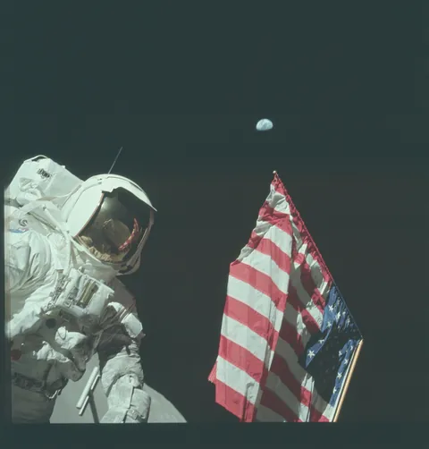 Apollo 17 Harrison "Jack" Schmitt took a break from moon walking to pose with the American flag and Earth, December 1972