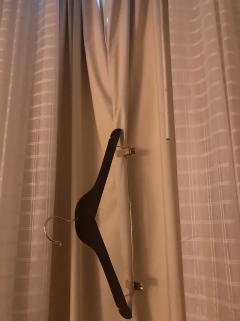 Hotel curtains letting in too much light?? Grab a hangar with clips and pinch it shut.