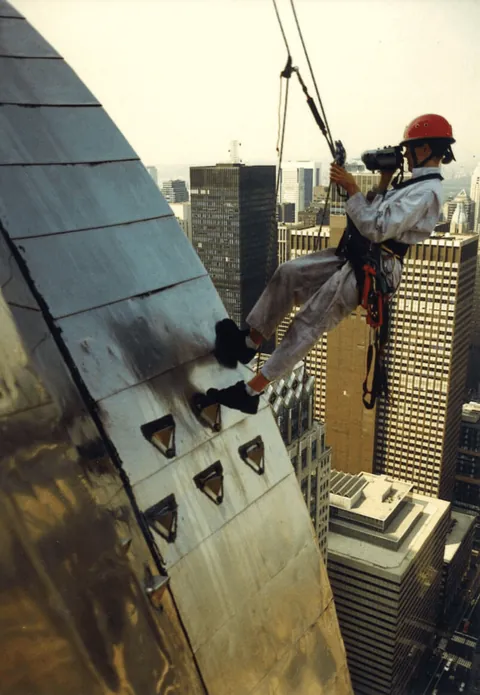 Checking the steel spire of the Chrysler Building for water leaks, New York