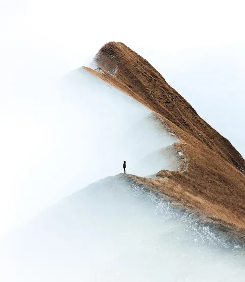 A girl standing on a ridge in Switzerland. Photo by Daniel Ernst.