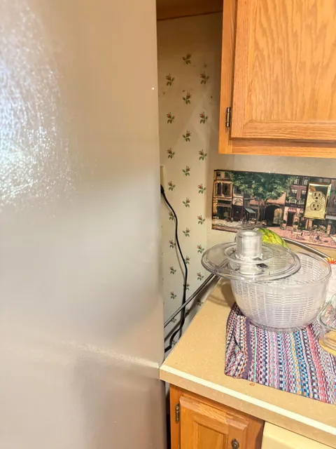 How would you guys go about getting this fridge to fit, it is VERY close.