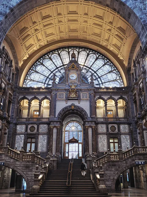 The main hall of Antwerp Central Station in Belgium and its famous staircase leading to the platforms. A true invitation to travel by train. [3000x4000][OC]