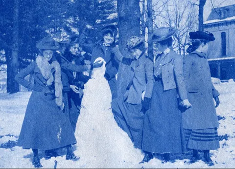 An unnamed young woman recorded her senior year at Asheville Female College in a photo album, Asheville, North Carolina, 1902. It includes a dorm room, group shots of friends, playing in snow, a visit to the mountains, their final midnight party before graduation, and graduation day itself.