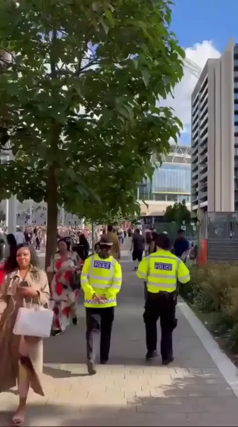 Jason Kelce greets a fan wearing his Eagle jersey in London.