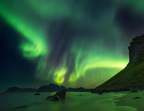 The moment when the aurora is so strong, it illuminates the landscape in green - Lofoten, Norway [OC][1800x1396]