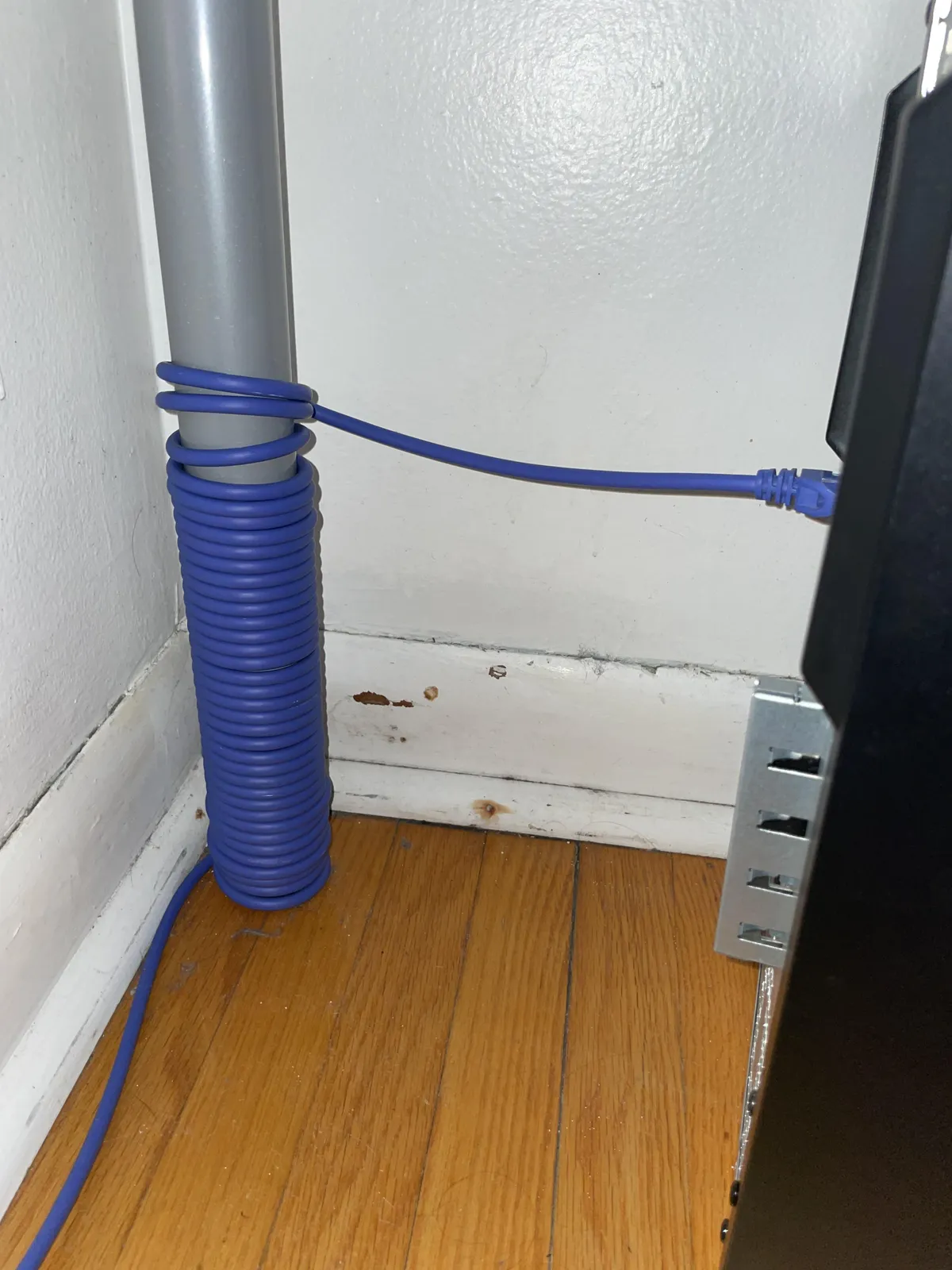 I have a very long Ethernet cable. Is it safe to have it wrapped around the leg of my desk like this?