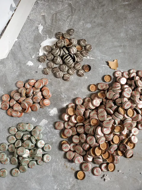 We found hundreds of 1960s bottle caps in our attic