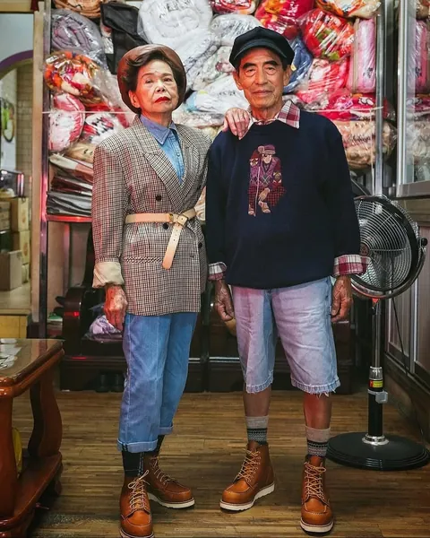 Taiwanese couple wear clothes that were left behind at their laundromat.