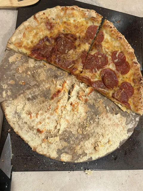 Husband baked pizza on the cardboard holder