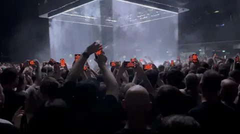 Pic of a concert the moment the stage changes colour but not the filming phones yet