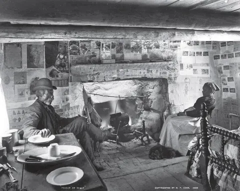American couple in their one-room cabin 1900.