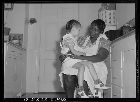 Little girl has a talk with the house maid, San Augustine, Texas, 1943