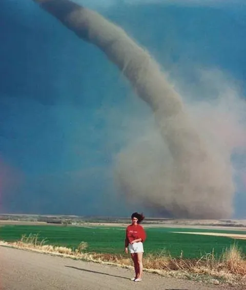 Nebraska girl, Audra Thomas, photographed in front of a tornado, 1989.