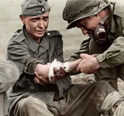 An American GI treating a wounded German soldier in WW2 (1940s).