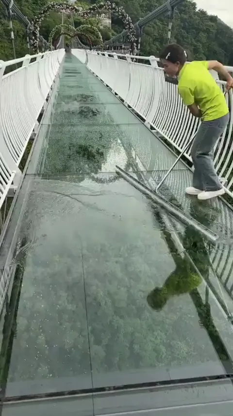 Mopping rainwater off transparent glass floors