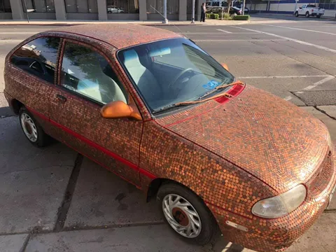 Found in Downtown Fresno, CA. Someone covered a Geo Metro with Pennies. Possibly doubled the value of the car.