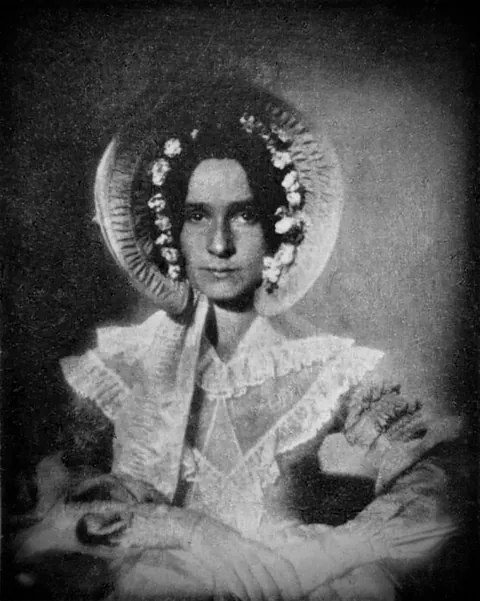 The first ever photograph of a woman taken in 1839, of Dorothy Catherine Draper. Her daguerreotype portrait is the only surviving contemporary photograph of someone wearing the 1830s poke bonnet, a pre Victorian hat.