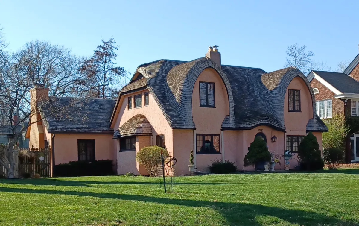 Distinctive home with curved eaves and peaks