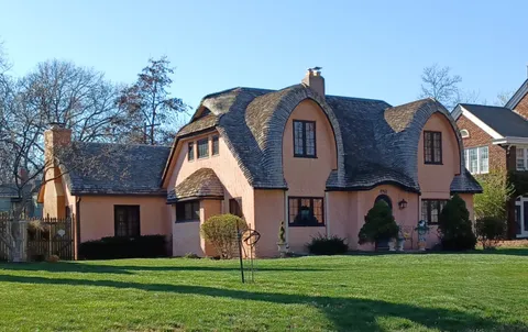 Distinctive home with curved eaves and peaks