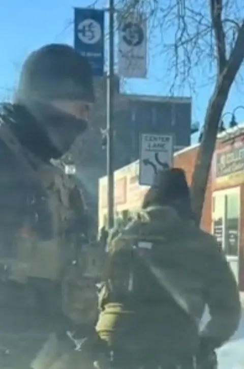 Alex Pretti's executioner wearing a Texas flag patch on his back.