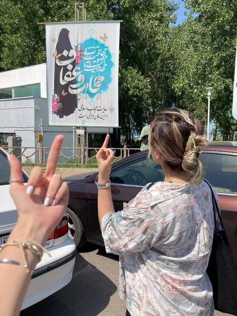 Iranian women making it a trend to take photos without hijab next to signs and billboards of hijab advertisement in Iran. 