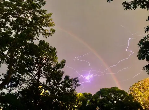 Caught a photo of lightning in my backyard with a rainbow. NSW, Australia