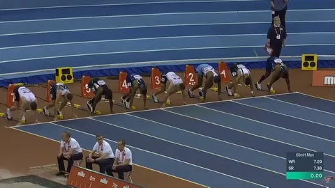 110 m hurdler Grant Holloway funnily skips over the finish line in this 60 m race as by muscle memory he was expecting another obstacle. Birmingham 2022.