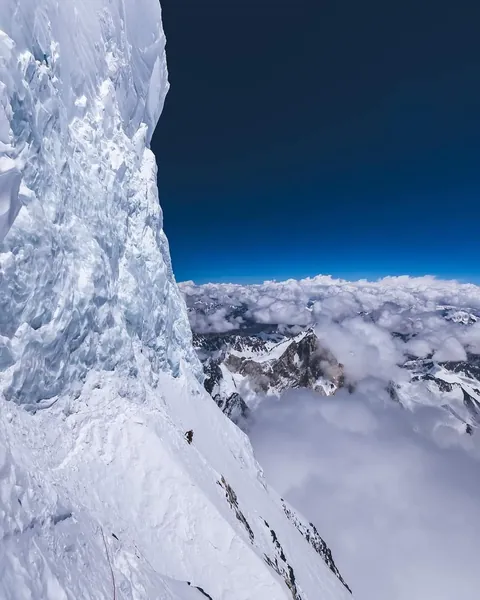 This is K2’s Bottleneck, a steep traverse above 8,000 metres beneath an enormous hanging serac capable of collapsing without warning. And somehow, this is considered the mountain’s standard route to the summit.