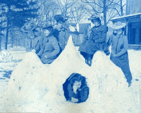 An unnamed young woman recorded her senior year at Asheville Female College in a photo album, Asheville, North Carolina, 1902. It includes a dorm room, group shots of friends, playing in snow, a visit to the mountains, their final midnight party before graduation, and graduation day itself.