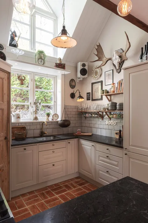 Kitchen with a clerestory window in a rustic 19th-century cottage, Eastern Gothenburg, Sweden [1440x2160]