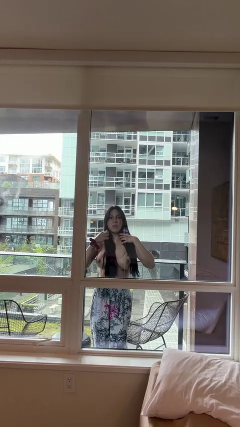 On the balcony I love to stick my breasts on the glass