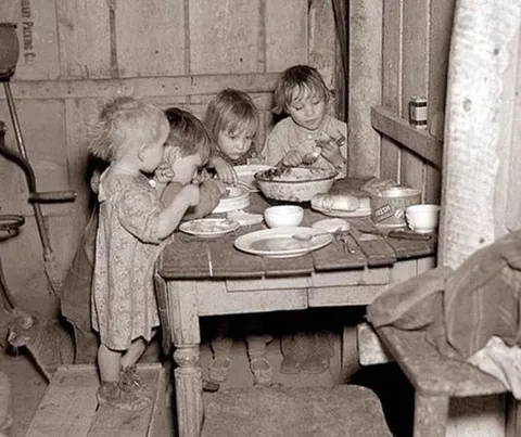 Children eating turnips and cabbage during the Great Depression, 1930's.