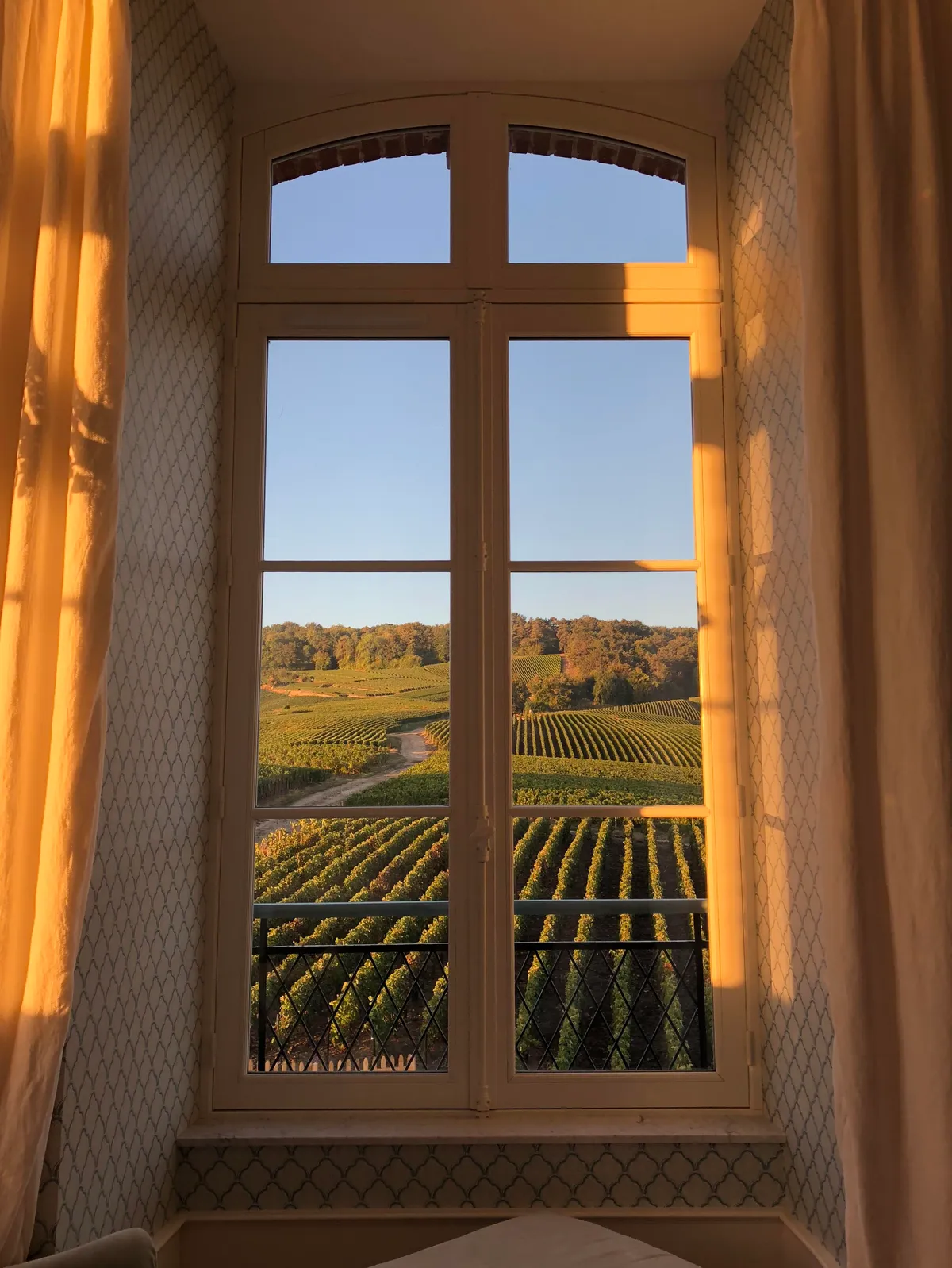 ITAP of our room window during sunrise in France's Champagne region.