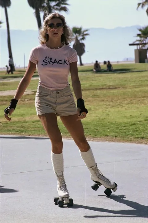Venice Beach California during the late 1970s roller skate craze. Still has some 70s vibe but you can feel the 80s coming.