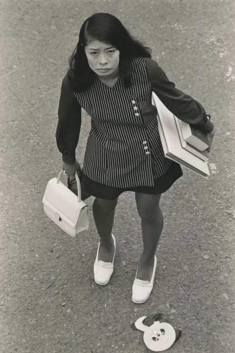 In 1974, Masahisa Fukase photographed his wife, Yōko Wanibe, every morning from the window of their apartment in Tokyo as she left for work.