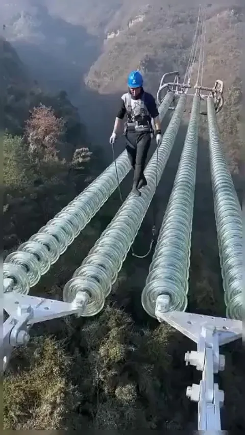 a powerline technician is one of the most dangerous works ever , but this brave guy doesn't care he's just working and smiling👏 👏