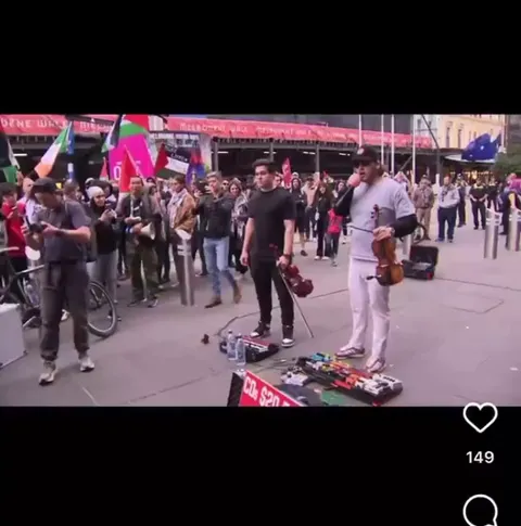Protesters get angry at two guys playing violin