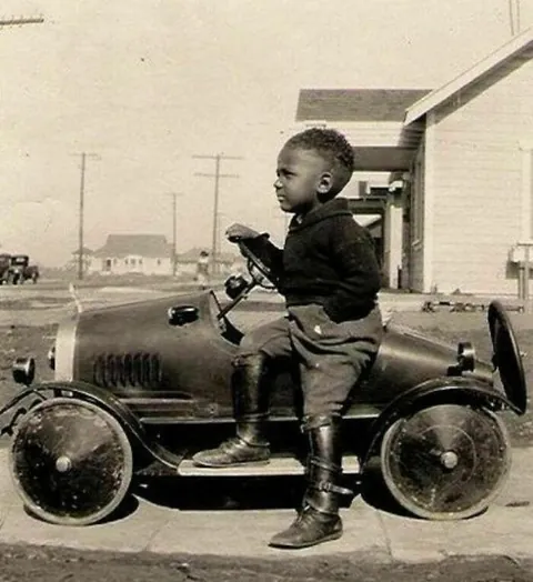 Little Man Posing Proudly with his New Ride; circa 1930s