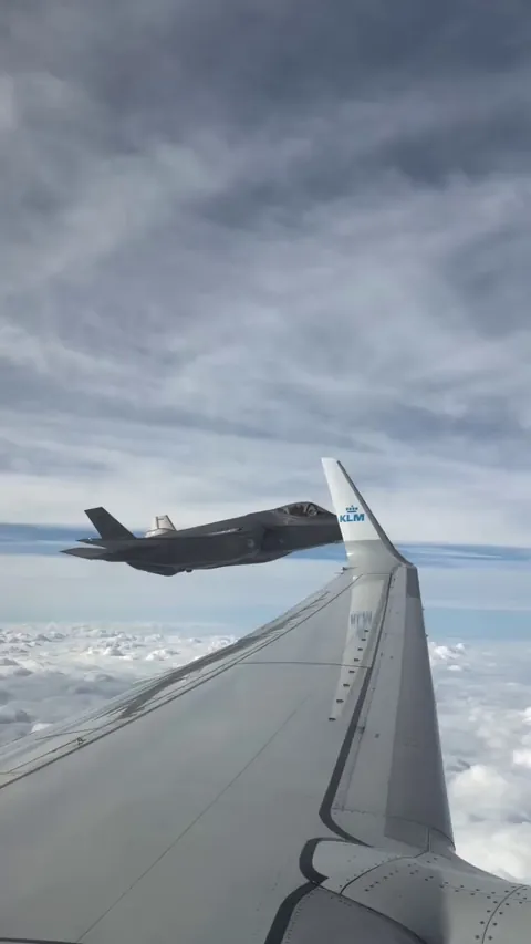 F-35 fighter jet escorts KLM flight carrying Dutch 2026 Olympic team home