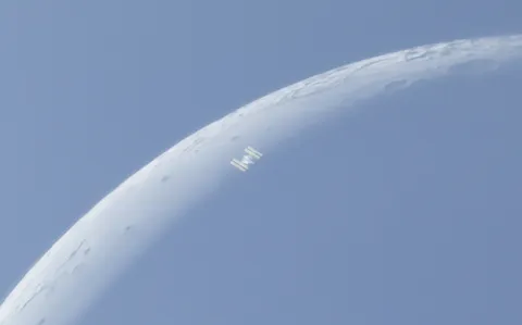 Yesterday morning I captured one of my favorite pictures ever, the international space station caught perfectly against the terminator of a barely illuminated crescent moon. Full pic in the comments. [OC]