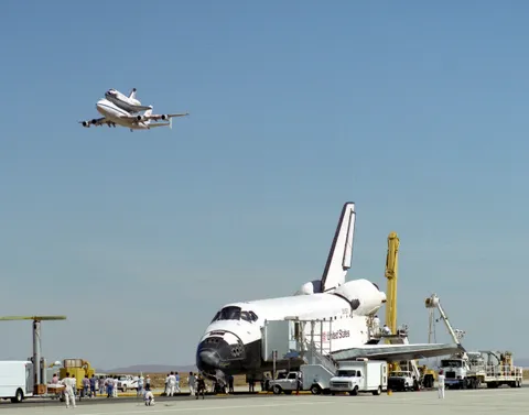 NASA's Space Shuttle Endeavour (STS-68) "receives a high-flying salute from its sister shuttle, Columbia, atop NASA's Shuttle Carrier Aircraft, shortly after Endeavor's landing" on 11 October 1994 at Edwards, California, United States of America. Photographer: Tony Landis, NASA