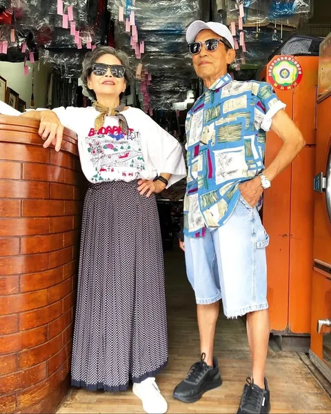 Taiwanese couple wear clothes that were left behind at their laundromat.