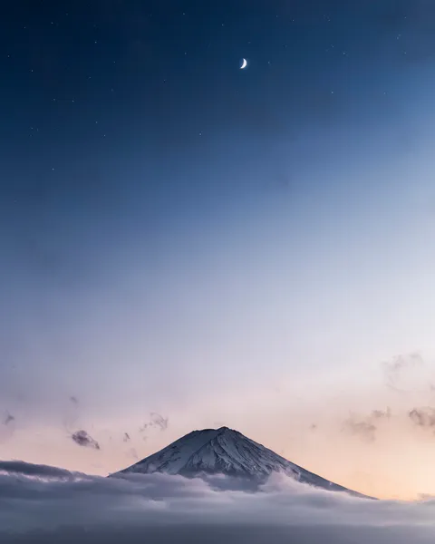I went to see Mt. Fuji twice during my trip to Japan only to find it completely covered in clouds. This was taken during a short break in the upper clouds just around blue hour. [3648x4560][OC]
