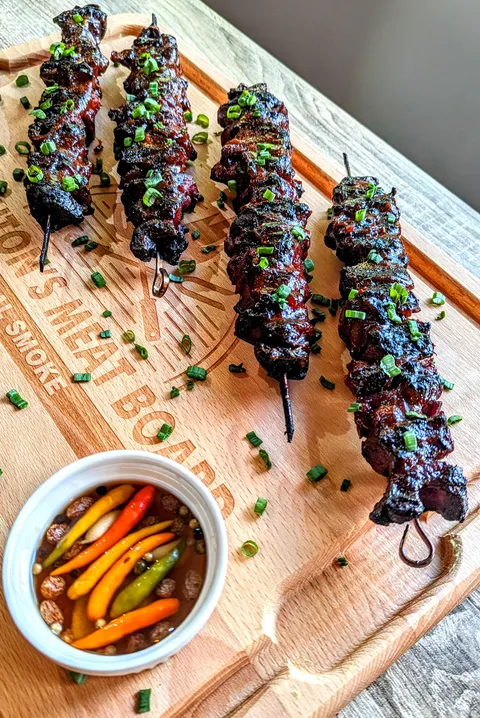 Filipino charred pork skewers with sukang sawsawan (spiced vinegar)