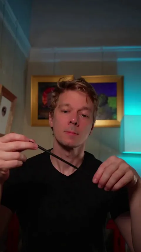 Artist paints using only black colour and reflections