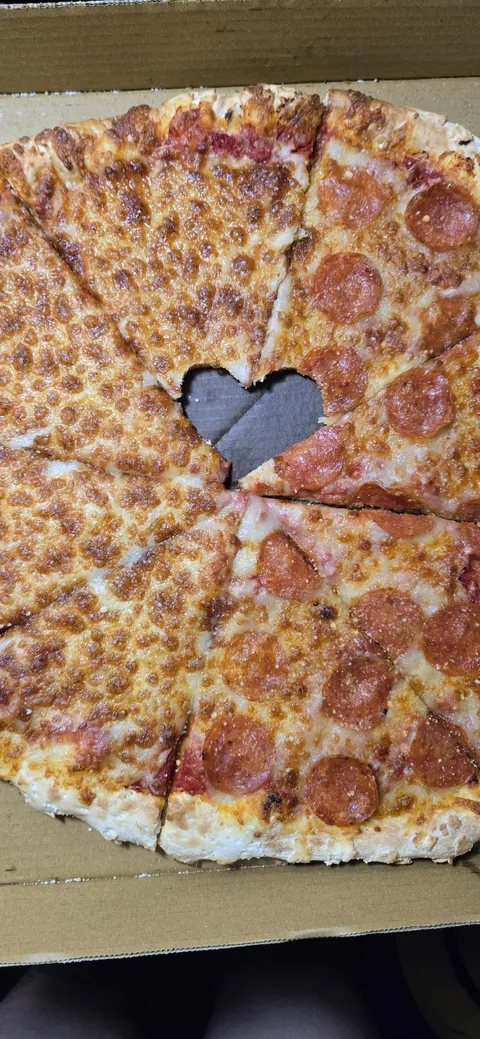 My husband and I each took a bite before we took our pizza home, accidental heart!
