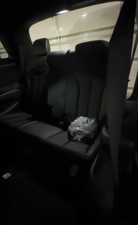 Woman shows the dangers of her cars rear seats folding function