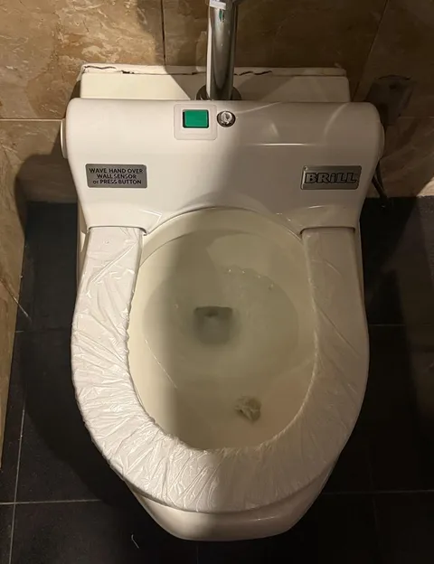 This toilet seat has a plastic film that rotates and is replaced when you click the button
